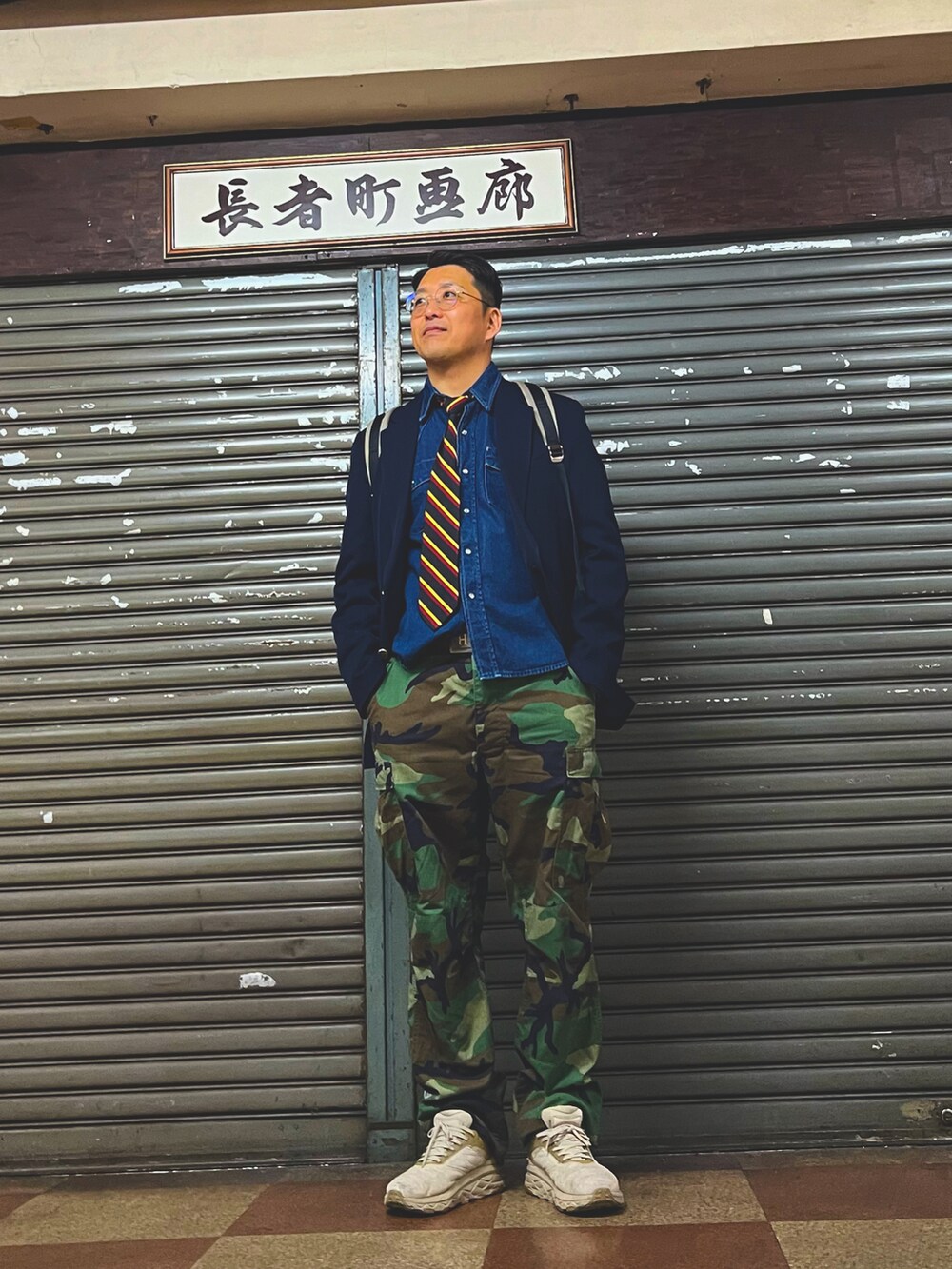 グリーン系のカーゴパンツ、ベージュ系のスニーカー、ブルー系のテーラードジャケットを着用したメンズの春コーディネートの4枚目の写真