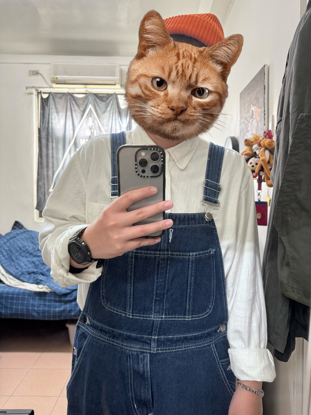 ブルー系のサロペット/オーバーオール、ホワイト系のシャツ/ブラウス、オレンジ系のニットキャップ/ビーニーを着用したレディースの冬コーディネートの2枚目の写真