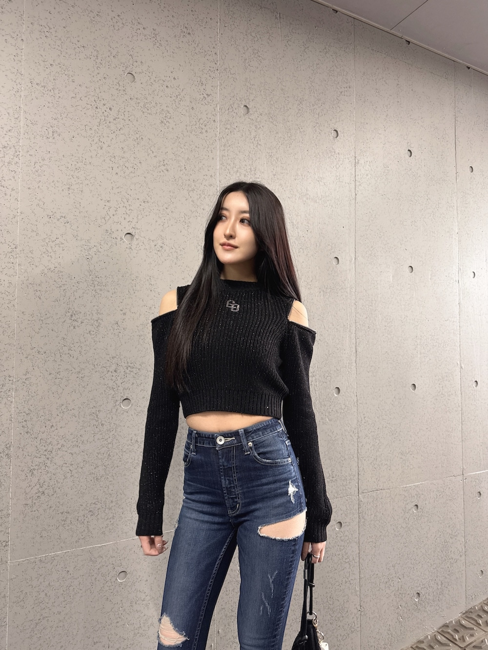 ブラック系のニット/セーター、ブラック系のブーツを着用したレディースの冬コーディネートの2枚目の写真