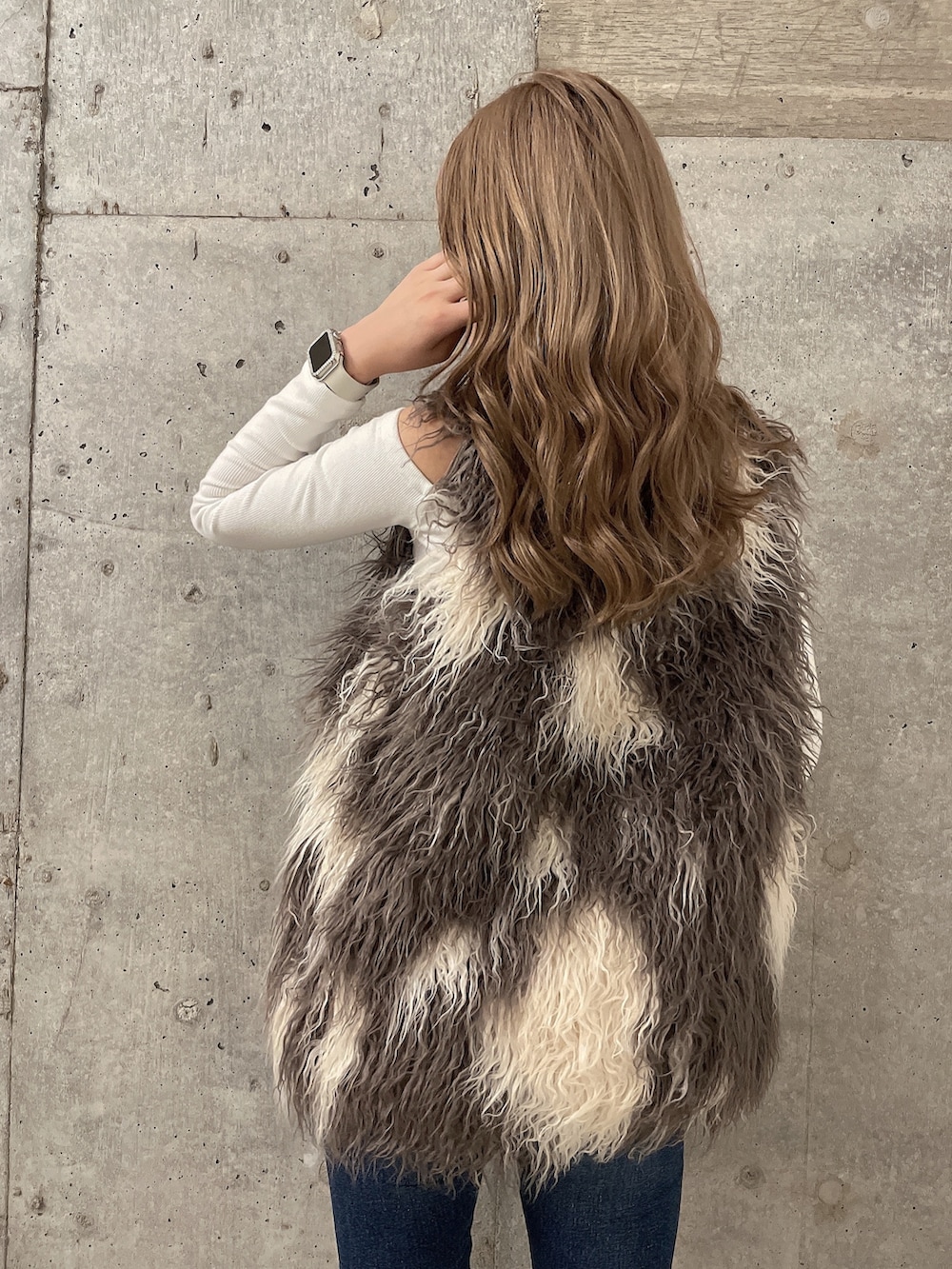 ホワイト系のTシャツ/カットソー、その他のベスト、ブルー系のデニムパンツを着用したレディースの秋コーディネートの4枚目の写真