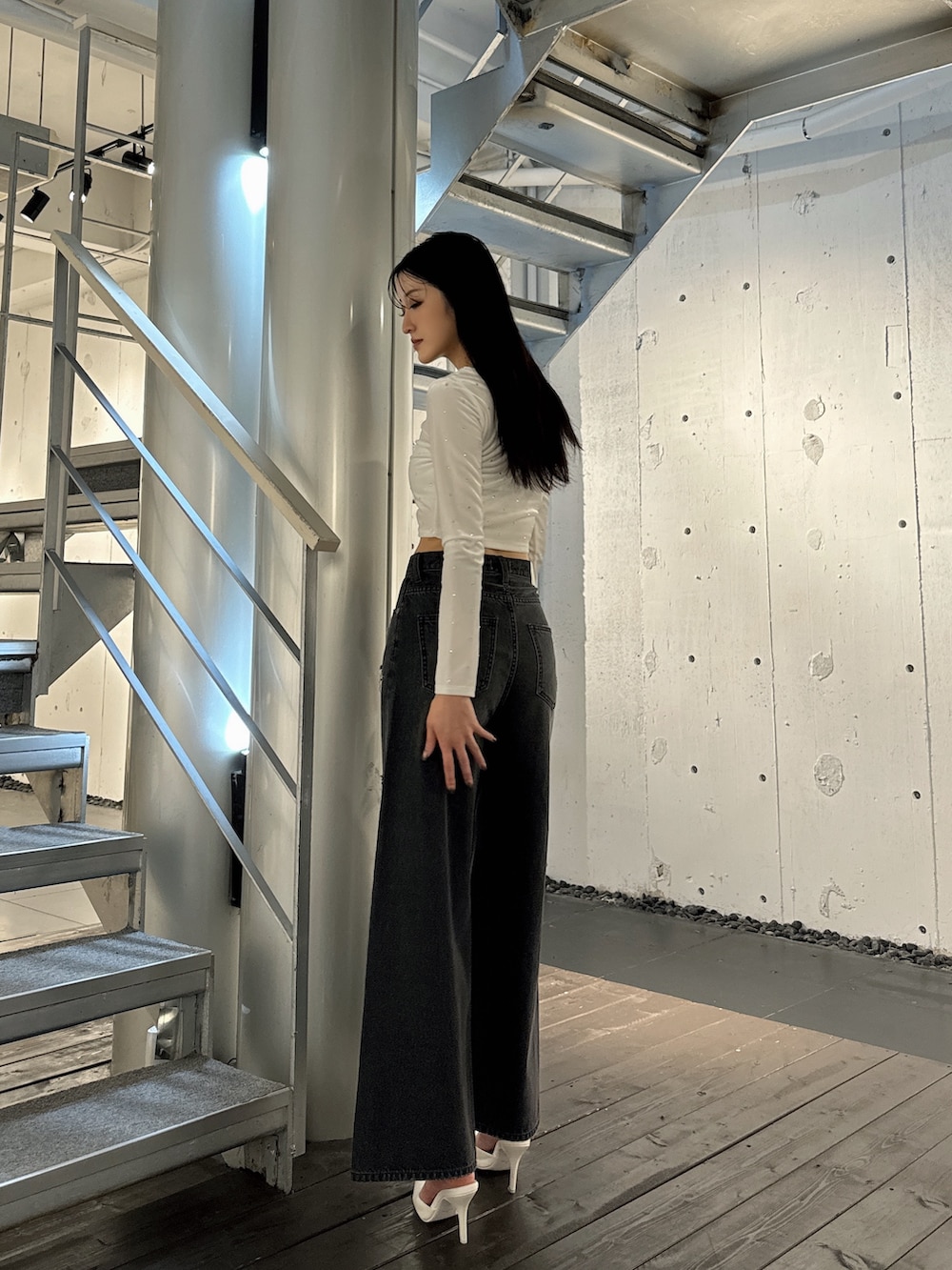 ホワイト系のTシャツ/カットソー、ブラック系のデニムパンツ、ホワイト系のパンプスを着用したレディースの秋コーディネートの2枚目の写真