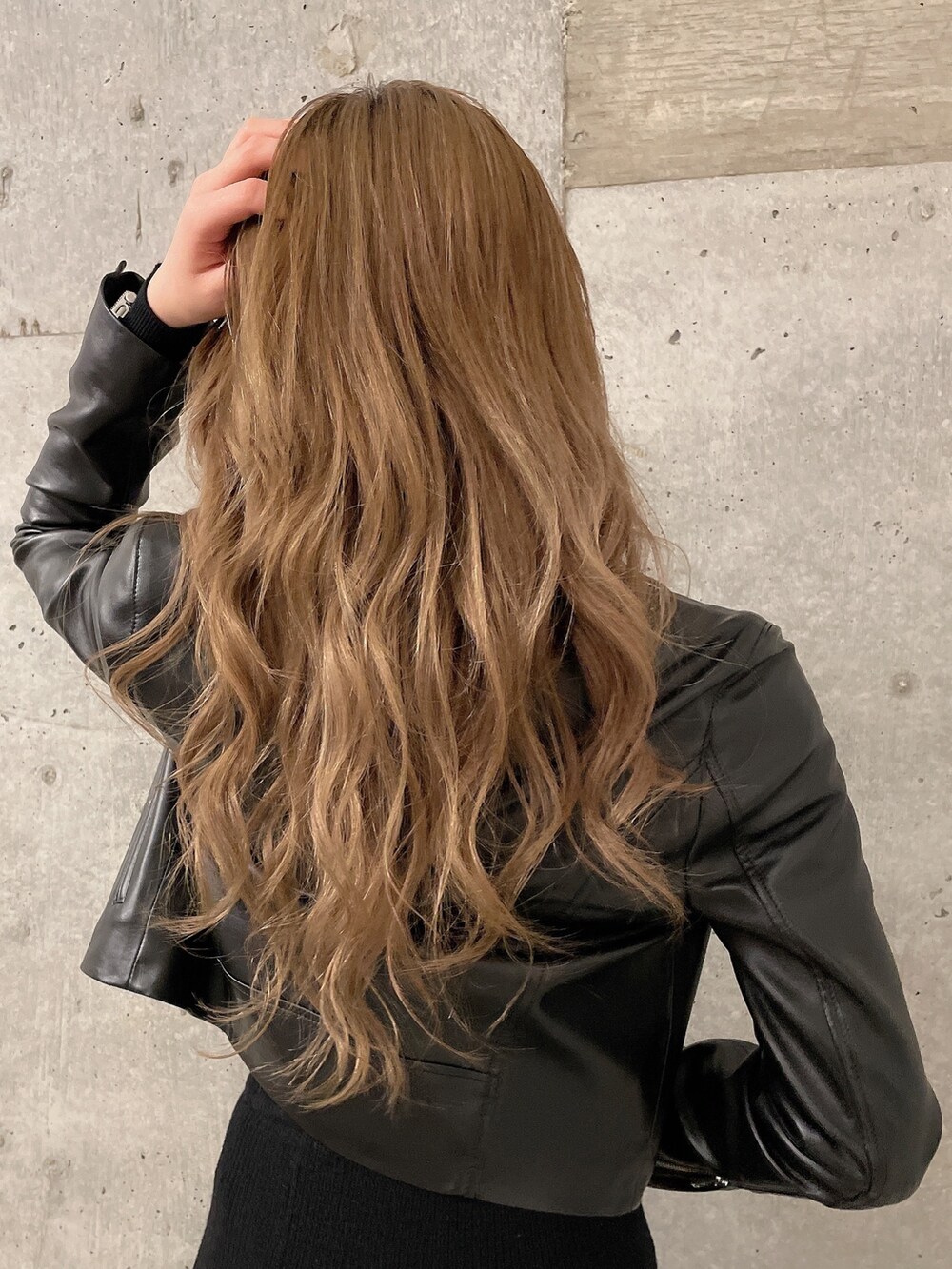 ブラック系のニット/セーター、ブラック系のスカート、ブラック系のライダースジャケットを着用したレディースの冬コーディネートの5枚目の写真