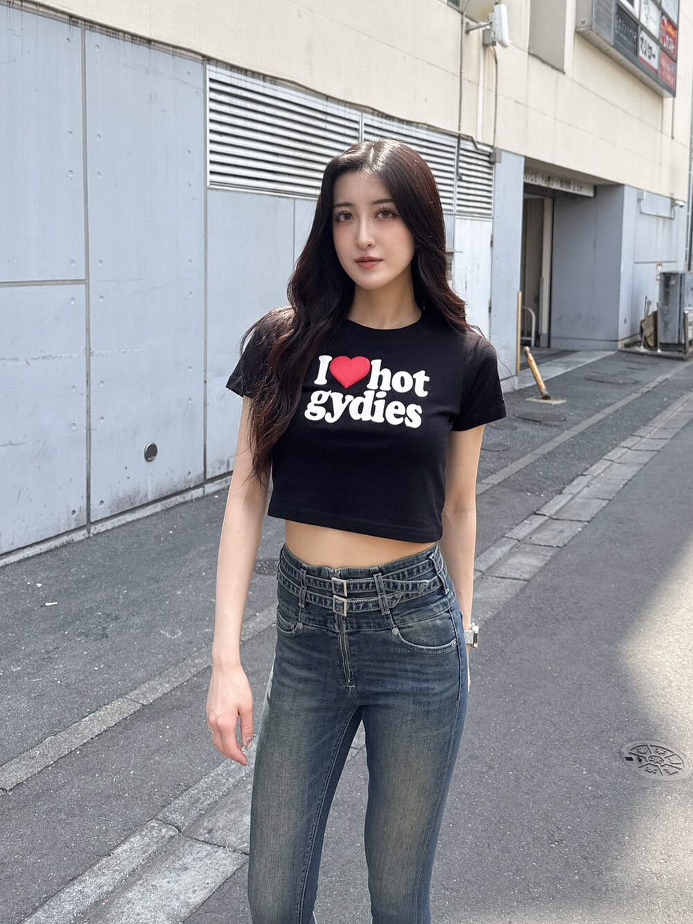 ブラック系のTシャツ/カットソー、ブルー系のデニムパンツ、ブラック系のサンダルを着用したレディースの春コーディネートの4枚目の写真