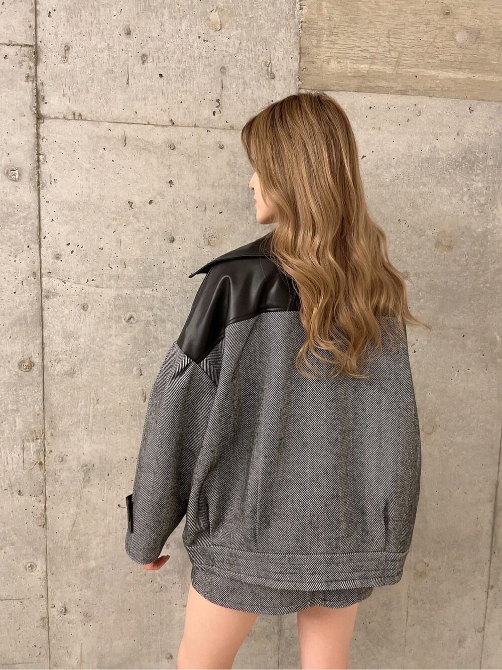 ブラック系のブーツ、ブラック系のニット/セーター、ブラック系のライダースジャケットを着用したレディースの秋コーディネートの3枚目の写真