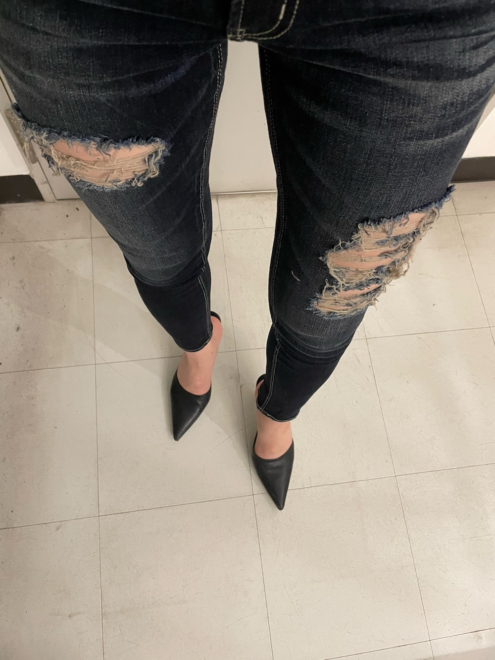 ホワイト系のスウェット、ブルー系のデニムパンツ、ブラック系のパンプスを着用したレディースの夏コーディネートの5枚目の写真