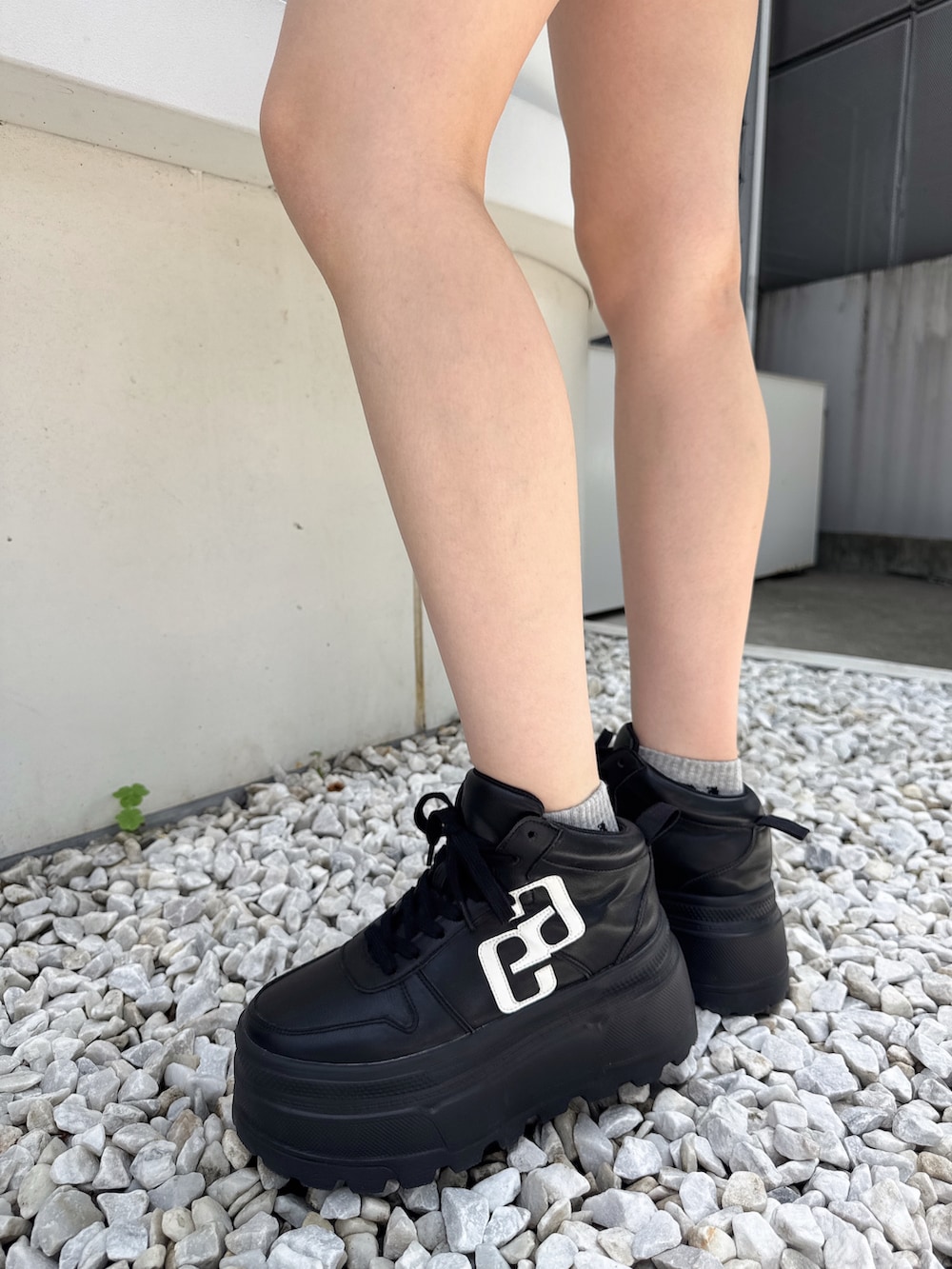 ブラック系のTシャツ/カットソー、ホワイト系のデニムパンツ、ブラック系のスニーカーを着用したレディースの夏コーディネートの4枚目の写真