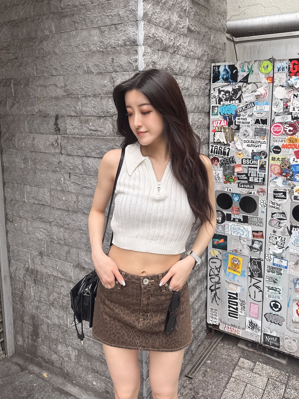 ホワイト系のニット/セーター、ベージュ系のスカート、ブラック系のサンダルを着用したレディースの夏コーディネートの2枚目の写真