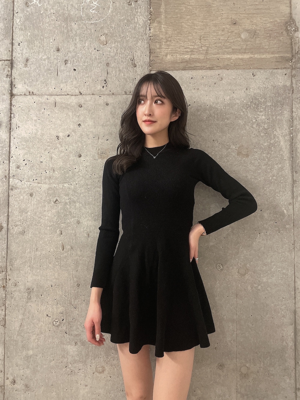 ホワイト系のダウンジャケット/コート、ブラック系のワンピース、ブラック系のブーツを着用したレディースの冬コーディネートの6枚目の写真