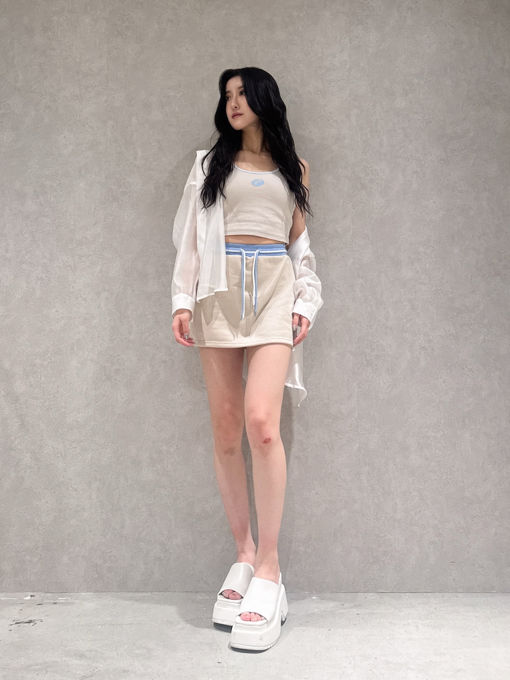 ベージュ系のスカート、ベージュ系のキャミソール、ホワイト系のサンダルを着用したレディースの夏コーディネートの4枚目の写真