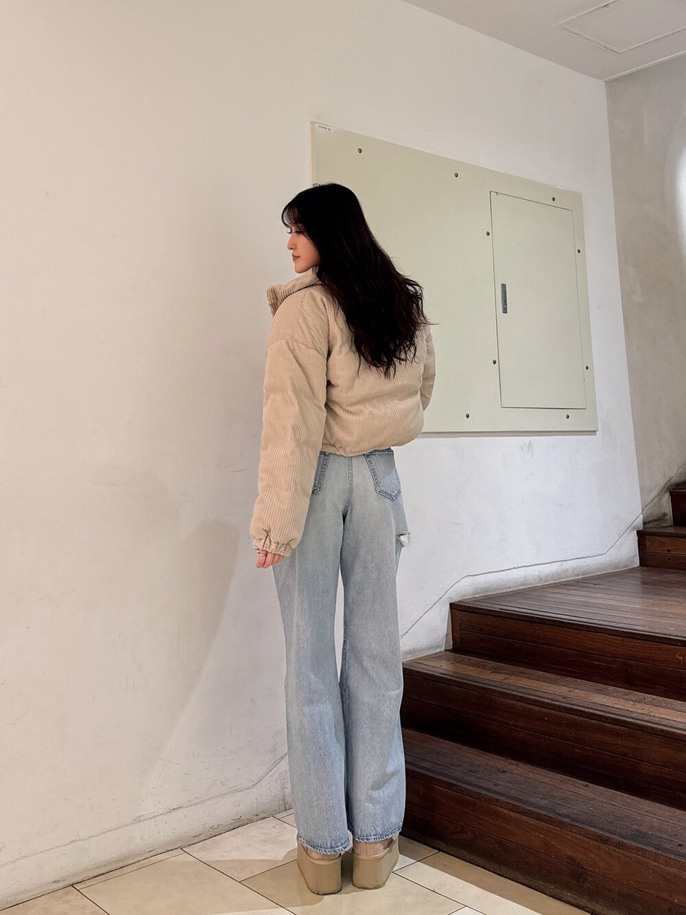 ホワイト系のニット/セーター、ブルー系のデニムパンツ、ベージュ系のブーツを着用したレディースの秋コーディネートの2枚目の写真