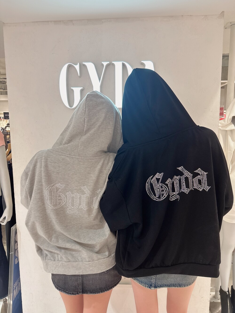 ブラック系のパーカー、ブルー系のデニムスカート、その他のキャミソールを着用したレディースの夏コーディネートの2枚目の写真