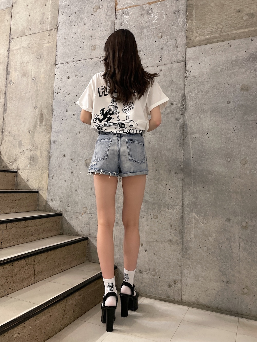 ホワイト系のTシャツ/カットソー、ブルー系のデニムパンツ、ブラック系のサンダルを着用したレディースの春コーディネートの2枚目の写真