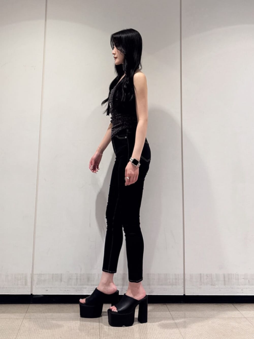 ブラック系のデニムパンツ、ブラック系のサンダル、その他のチューブトップを着用したレディースの夏コーディネートの2枚目の写真