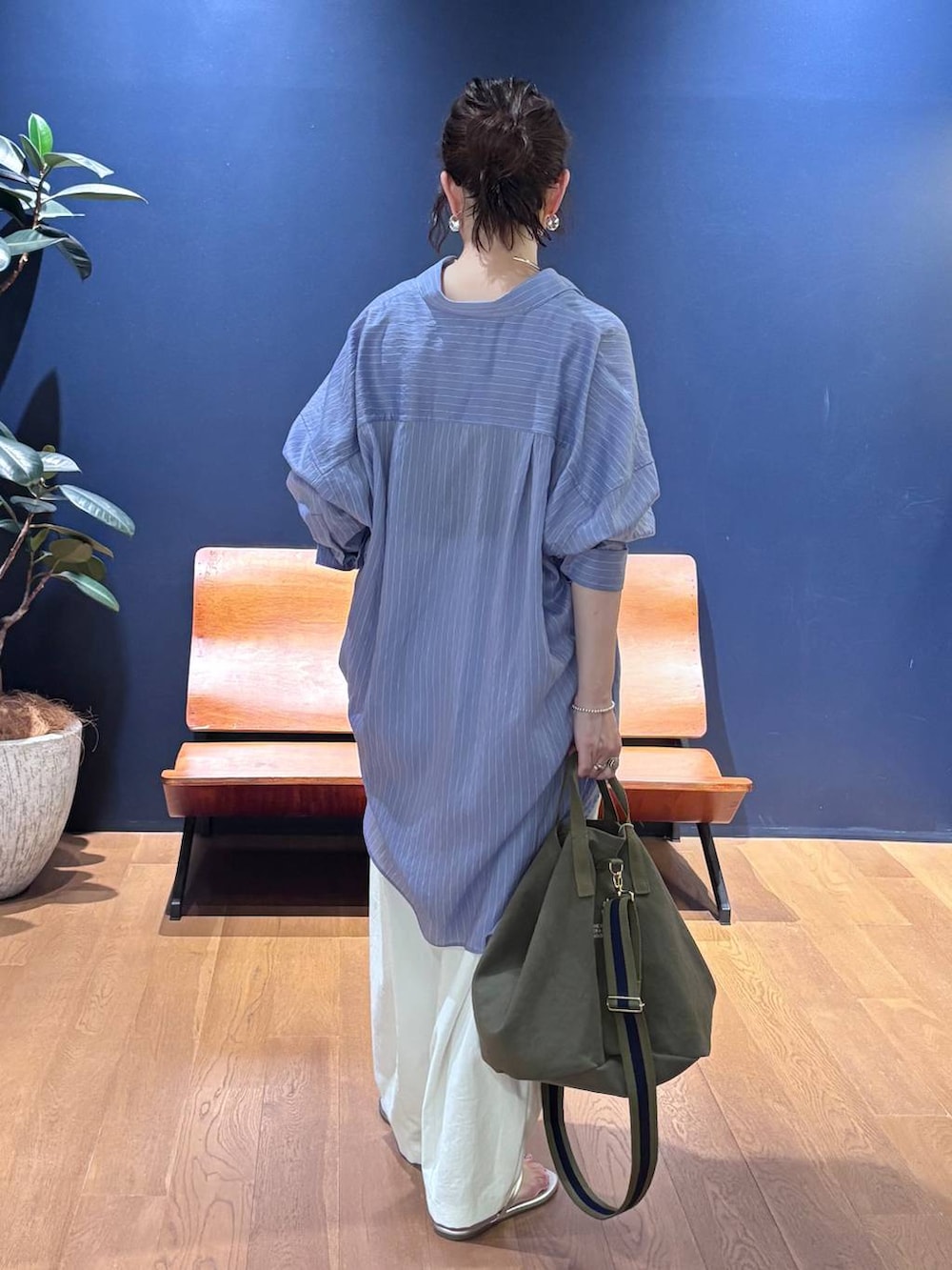 グリーン系のトートバッグ、ホワイト系のその他パンツ、ブルー系のシャツ/ブラウスを着用したレディースの夏コーディネートの3枚目の写真