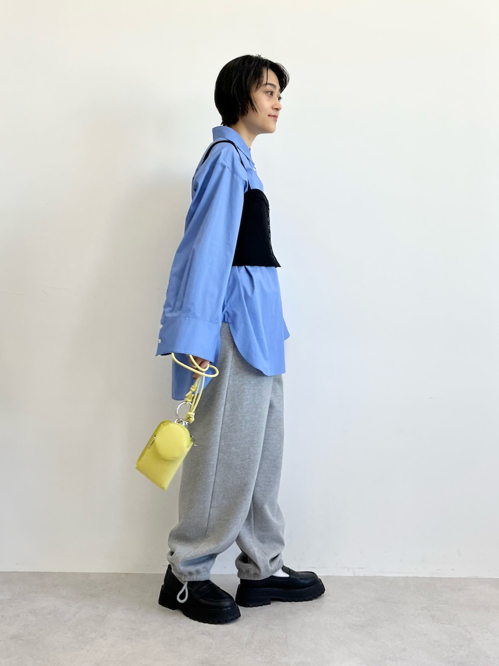 ブルー系のシャツ/ブラウス、ブラック系のブルゾン、ブラック系のベストを着用したレディースの冬コーディネートの4枚目の写真