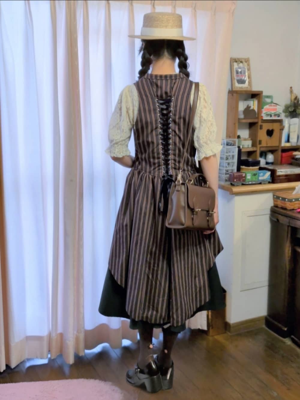 グリーン系のベスト、グリーン系のスカート、ホワイト系のTシャツ/カットソーを着用したレディースの夏コーディネートの2枚目の写真