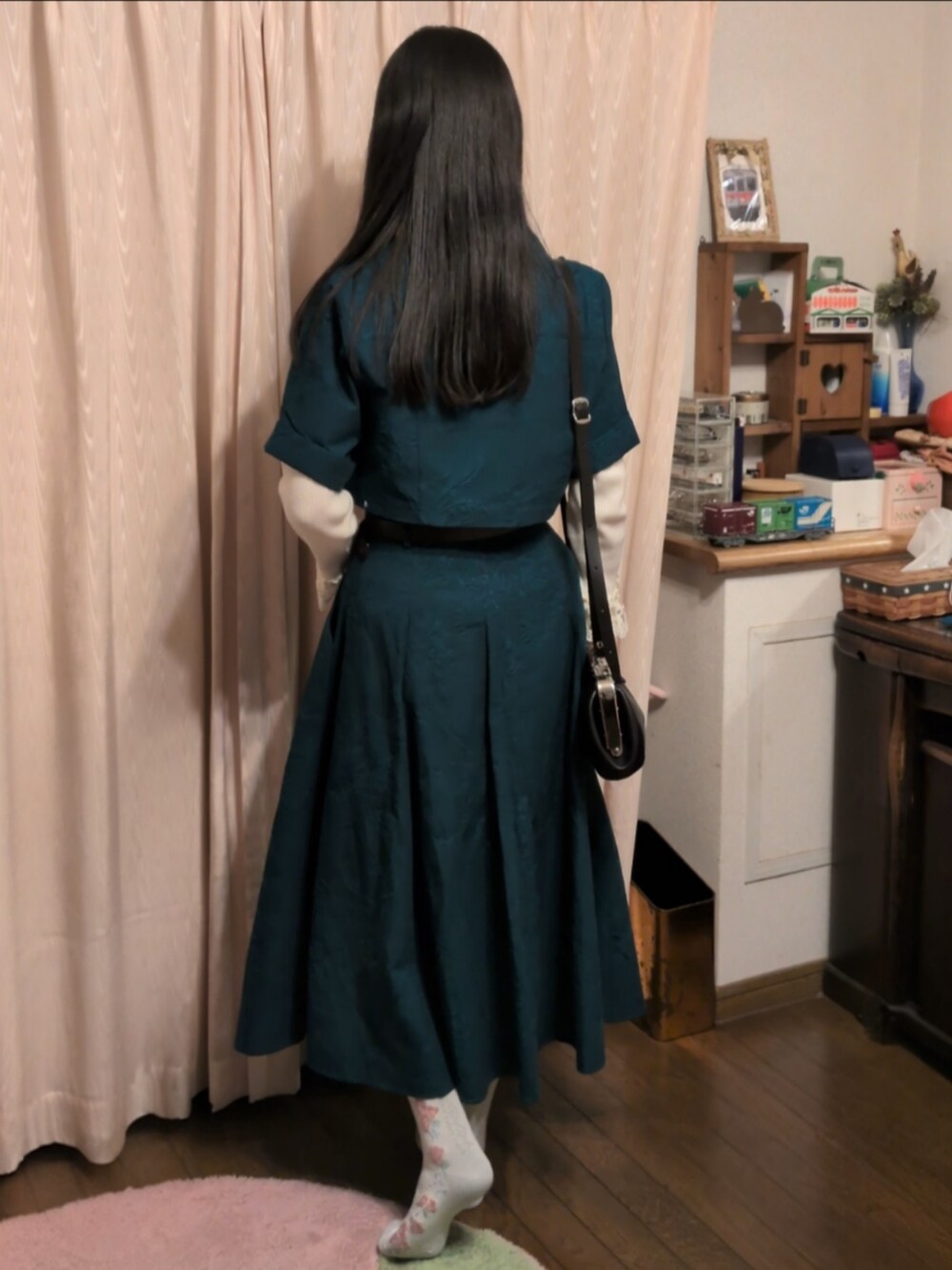 グリーン系のスカート、グリーン系のシャツ/ブラウス、ホワイト系のニット/セーターを着用したレディースの冬コーディネートの2枚目の写真