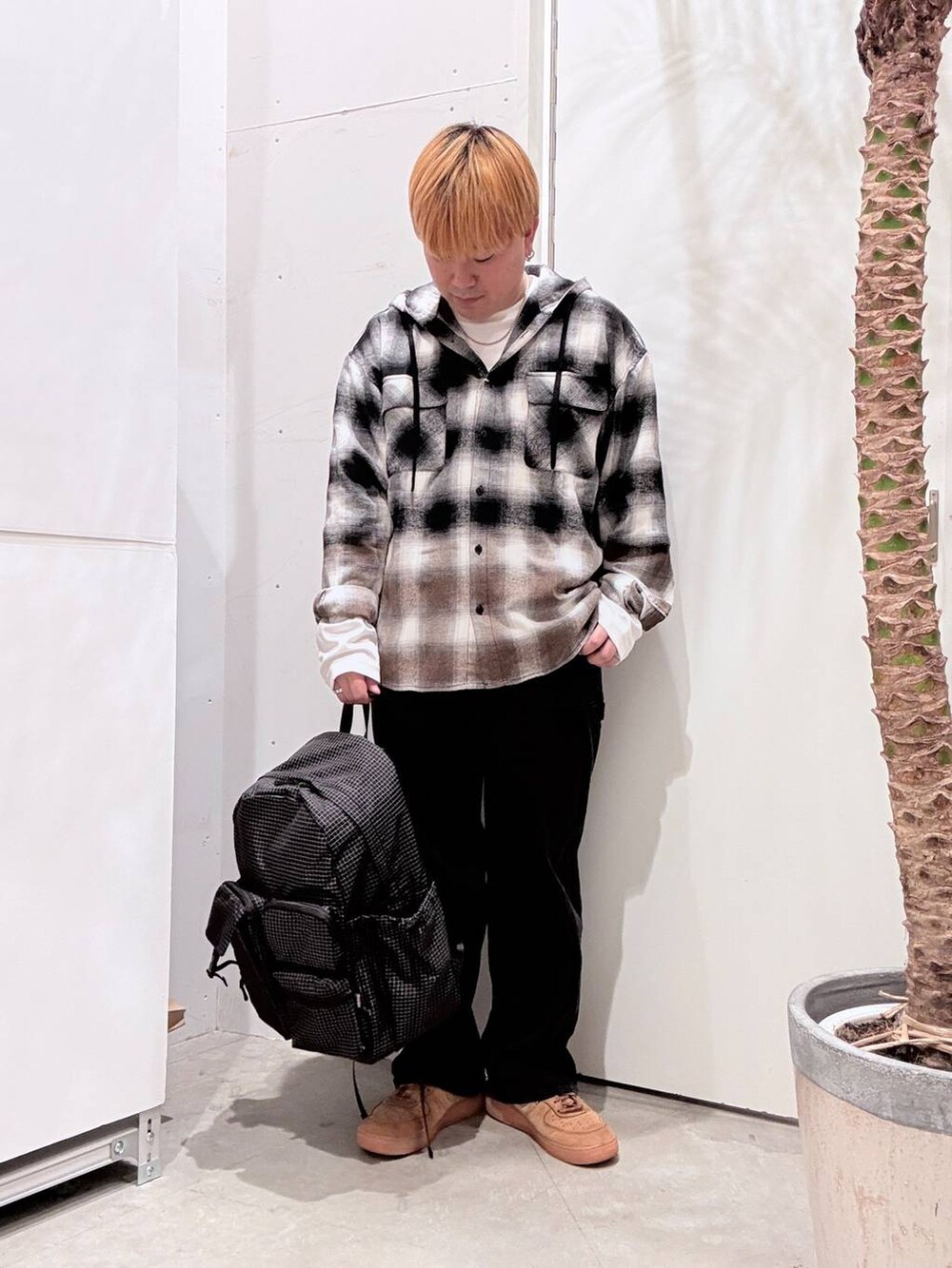 ブラック系のその他パンツ、ブラック系のバックパック/リュック、ホワイト系のTシャツ/カットソーを着用したメンズの秋コーディネートの2枚目の写真