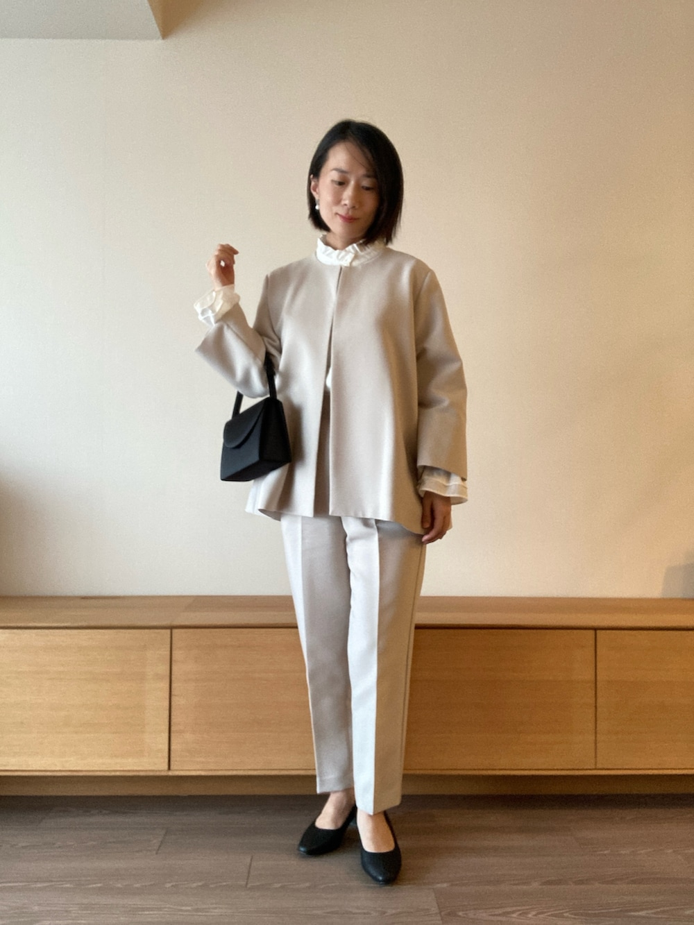 グレー系のスーツセットを着用したレディースの冬コーディネートの2枚目の写真