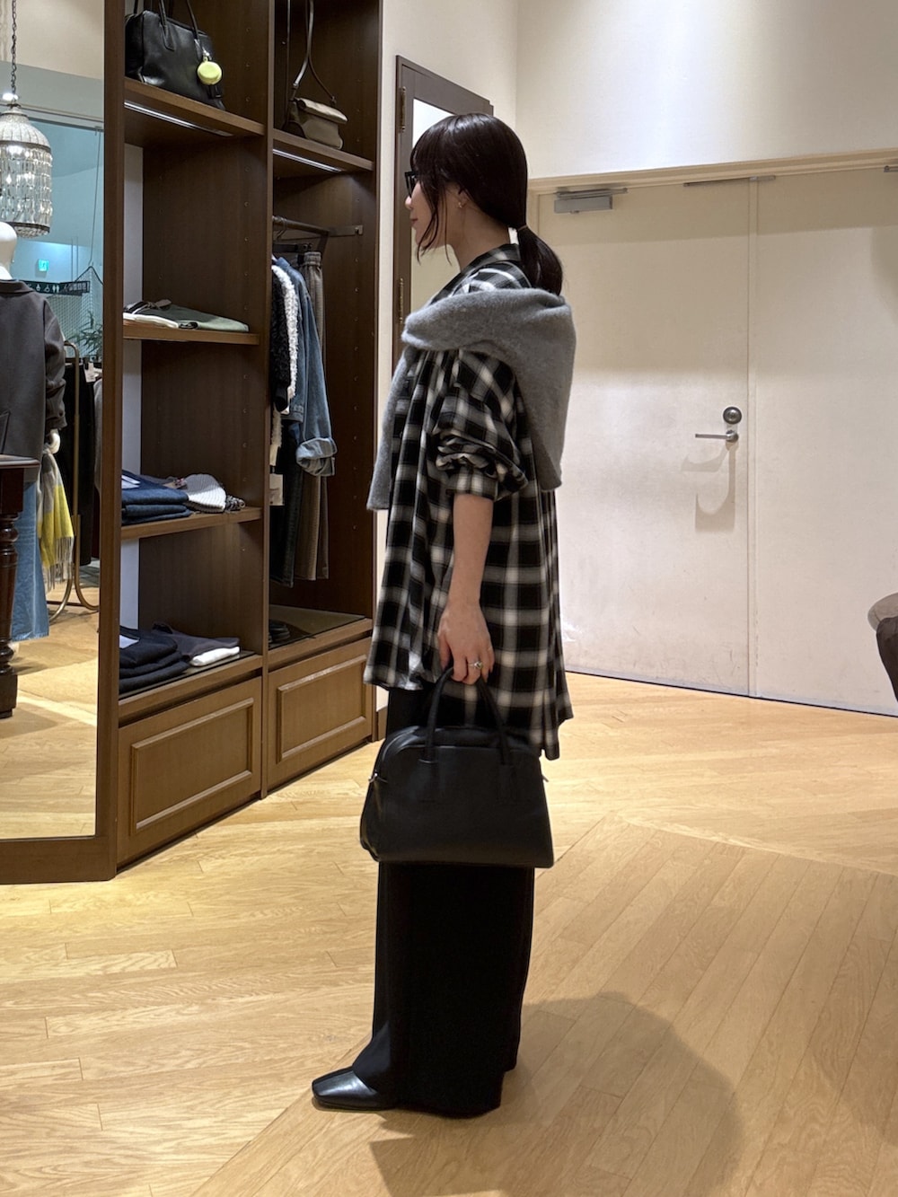 ホワイト系のTシャツ/カットソー、ブラック系のシャツ/ブラウス、ブラック系のスラックスを着用したレディースの秋コーディネートの2枚目の写真