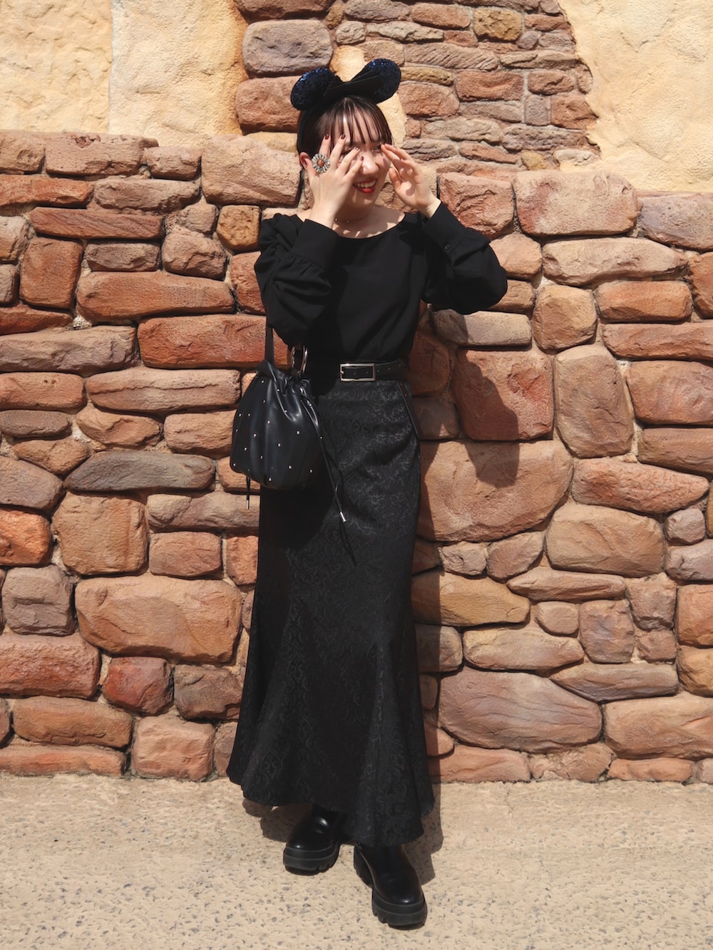 ブラック系のシャツ/ブラウス、ブラック系のスカート、ブラック系のブーツを着用したレディースの秋コーディネートの2枚目の写真