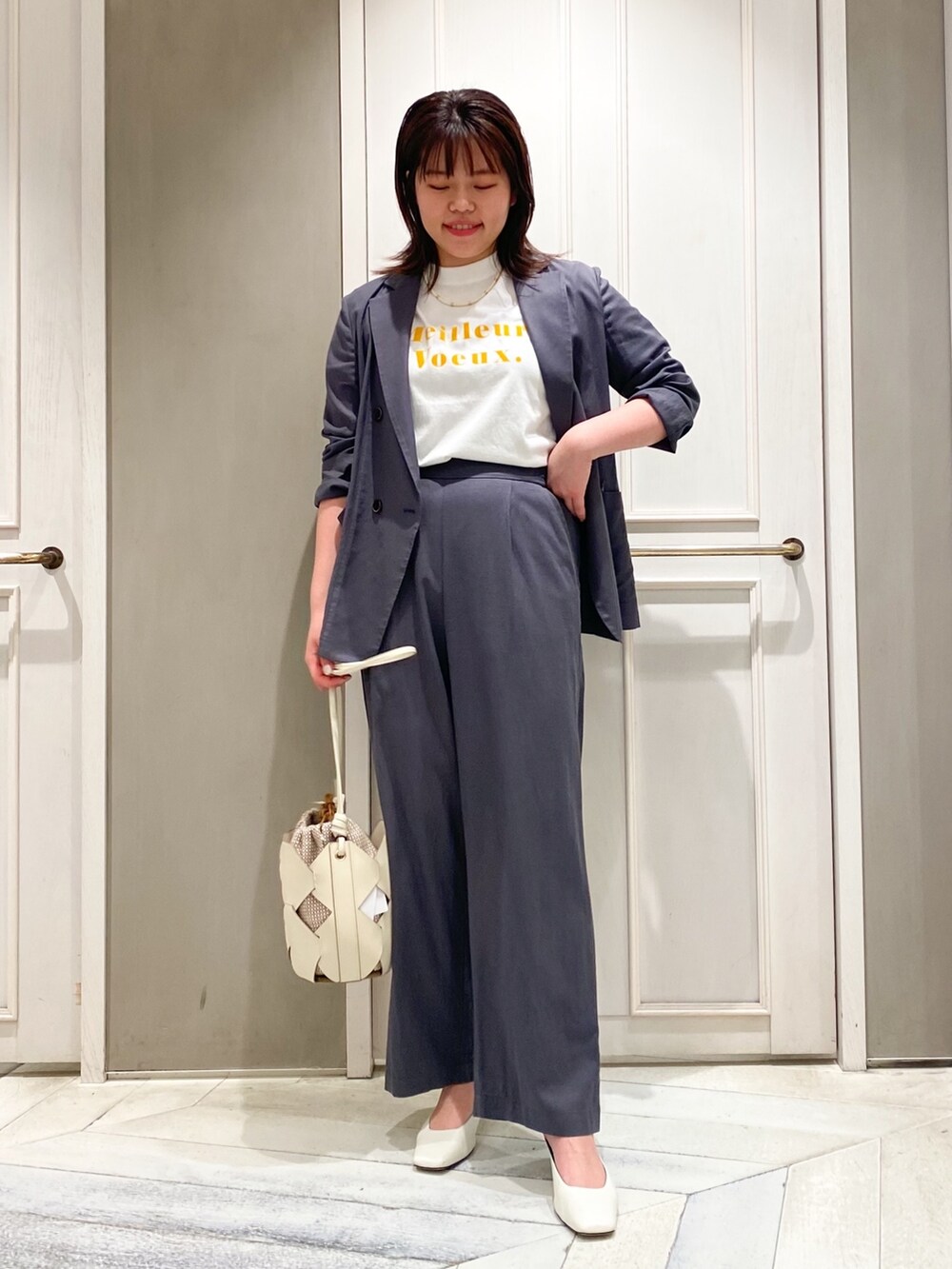 グレー系のその他パンツ、ホワイト系のショルダーバッグ、グレー系のテーラードジャケットを着用したレディースの春コーディネートの3枚目の写真