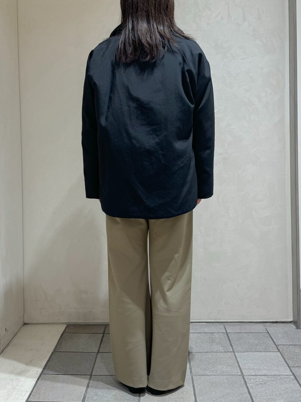 ブラック系のダウンジャケット/コート、グリーン系のスラックスを着用したレディースの秋コーディネートの6枚目の写真