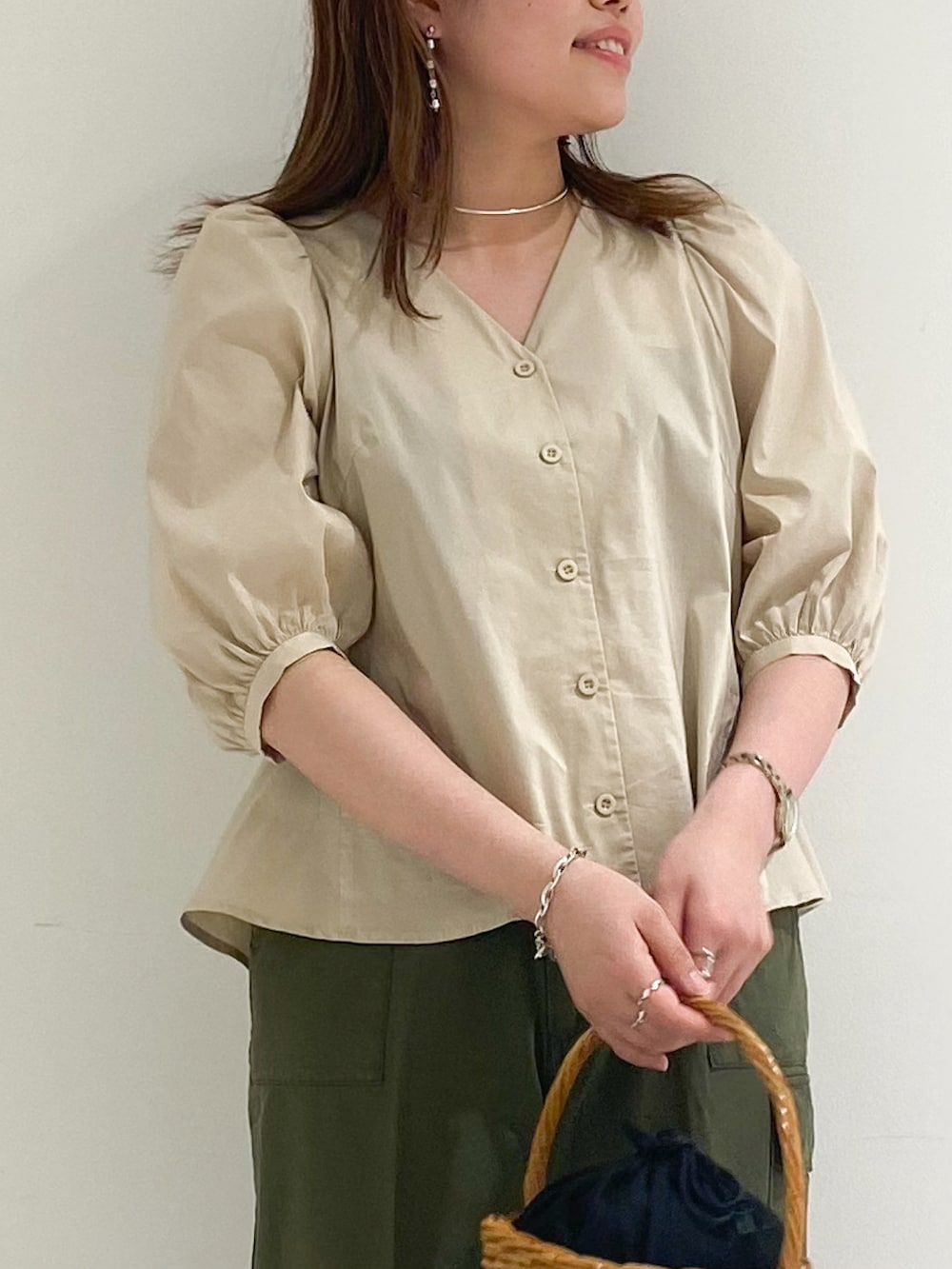 ベージュ系のシャツ/ブラウス、グリーン系のカーゴパンツ、ブラック系のかごバッグを着用したレディースの春コーディネートの4枚目の写真