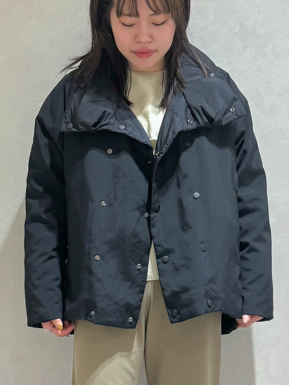 ブラック系のダウンジャケット/コート、グリーン系のスラックスを着用したレディースの秋コーディネートの4枚目の写真