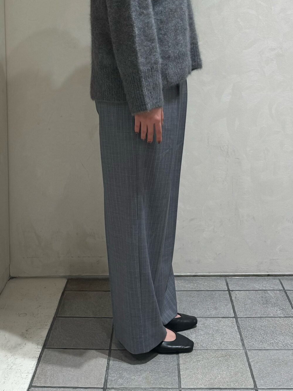 グレー系のニット/セーター、その他のスラックス、ブラック系のボストンバッグを着用したレディースの秋コーディネートの9枚目の写真