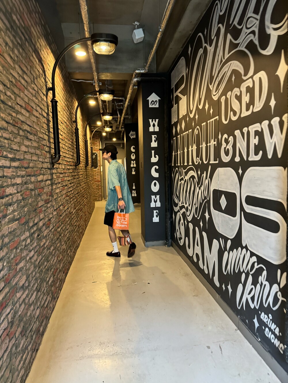 ブラック系のその他パンツ、レッド系のローファー、グリーン系のシャツ/ブラウスを着用したメンズの夏コーディネートの2枚目の写真