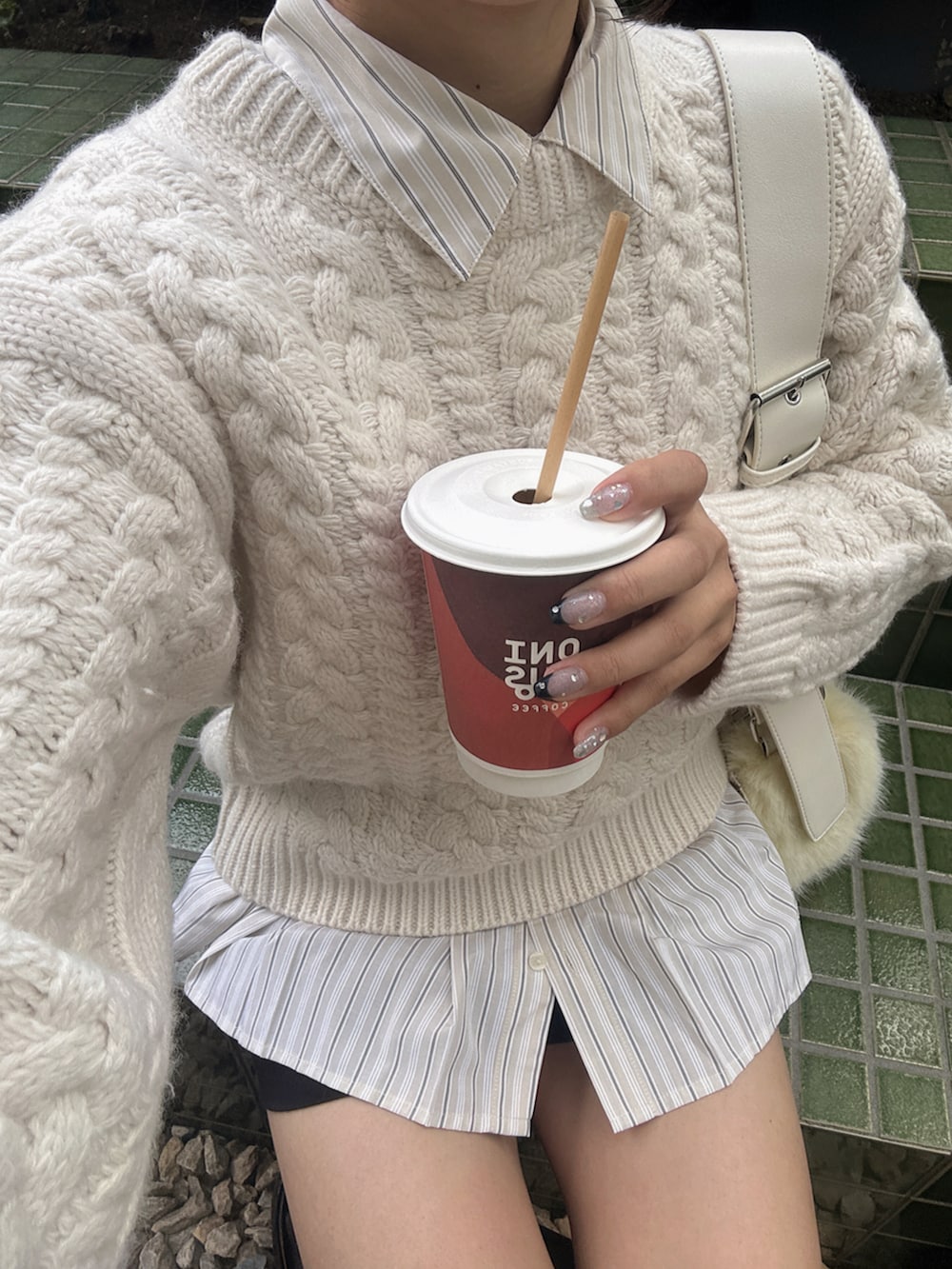 ホワイト系のニット/セーター、ベージュ系のシャツ/ブラウス、イエロー系のショルダーバッグを着用したレディースの秋コーディネートの3枚目の写真