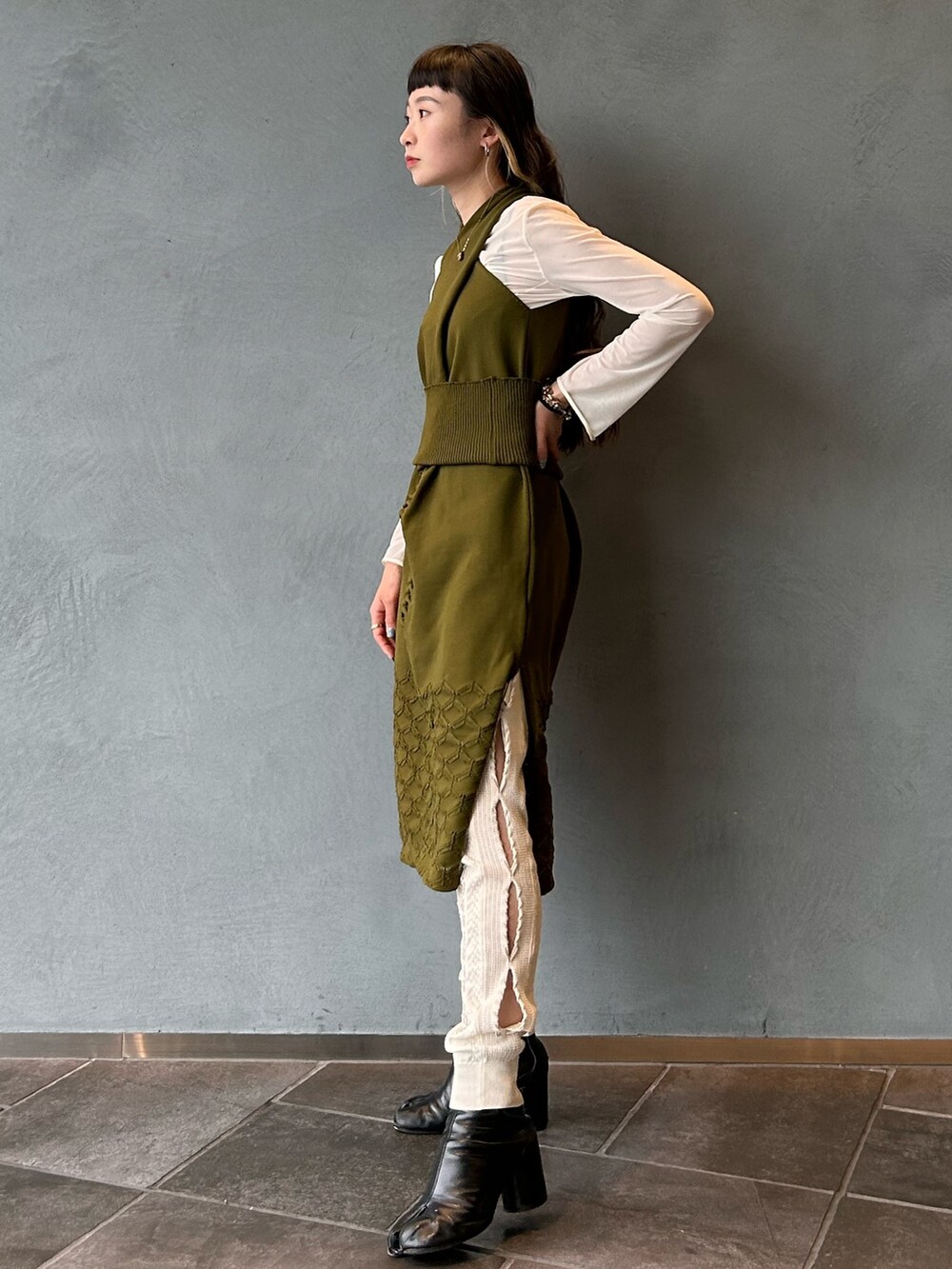 グリーン系のドレスを着用したレディースの春コーディネートの3枚目の写真