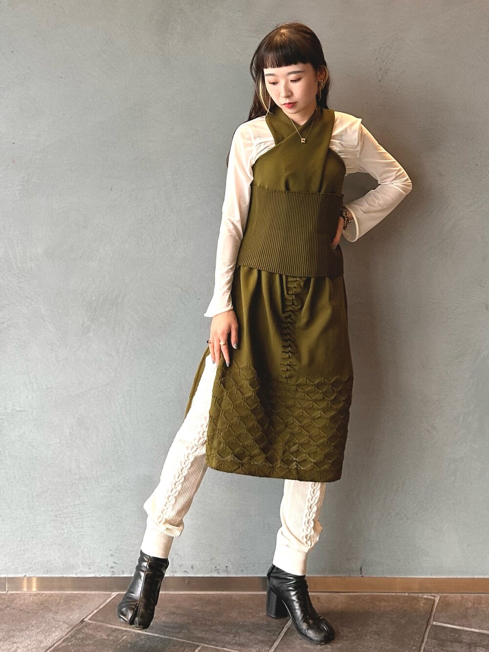 グリーン系のドレスを着用したレディースの春コーディネートの2枚目の写真