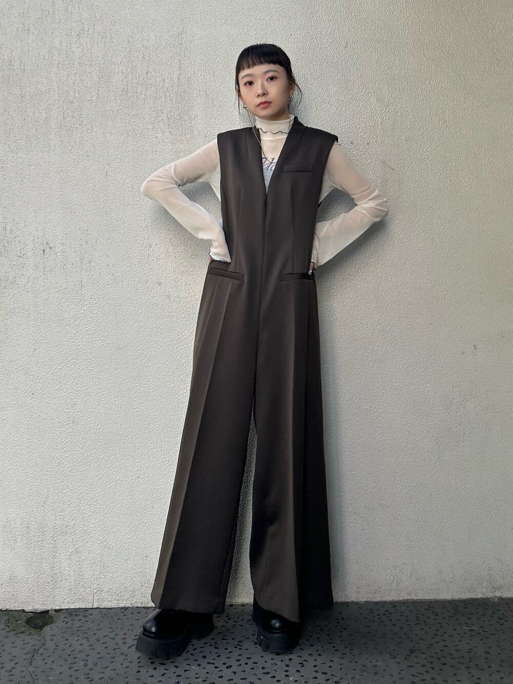 ブラック系のブーツ、ベージュ系のTシャツ/カットソーを着用したレディースの秋コーディネートの2枚目の写真