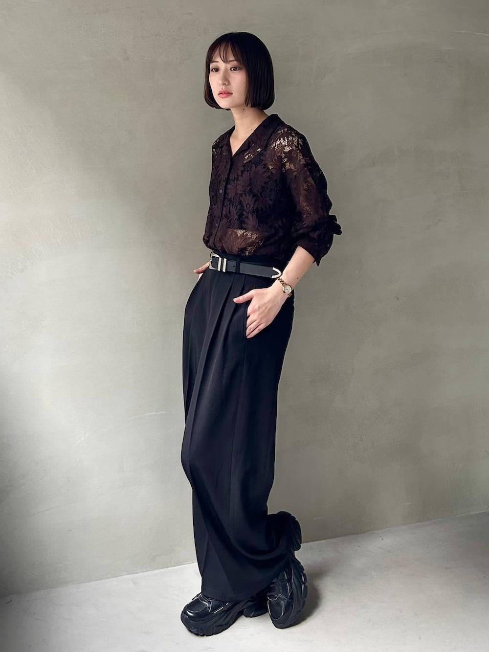 ブラック系のキャミソール、ブラック系のスラックス、ブラック系のスニーカーを着用したレディースの夏コーディネートの3枚目の写真