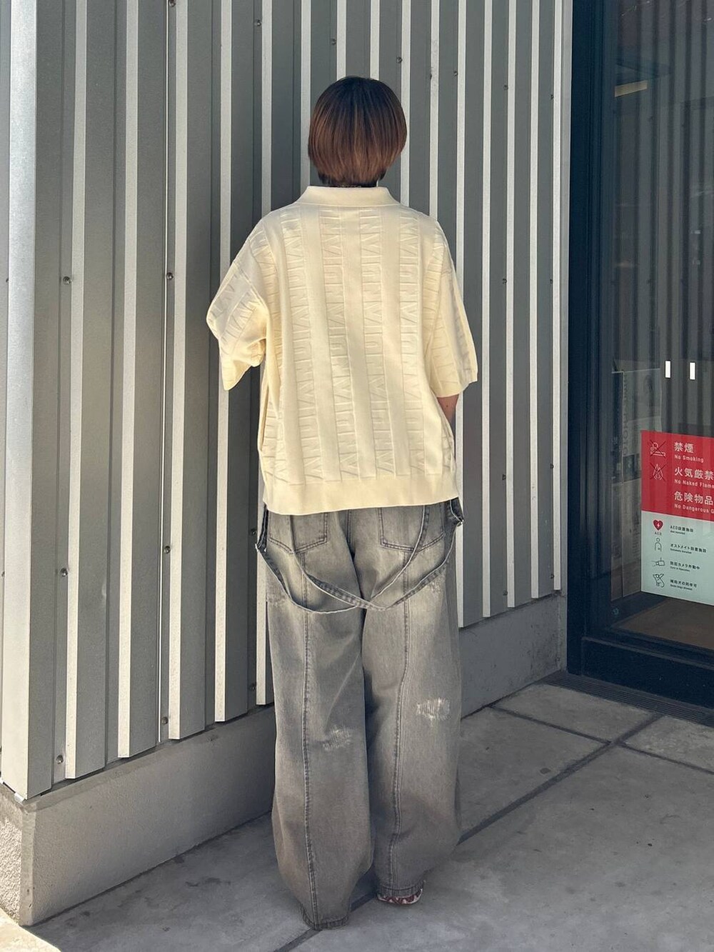 ブラック系のデニムパンツ、ホワイト系のニット/セーターを着用したレディースの春コーディネートの6枚目の写真