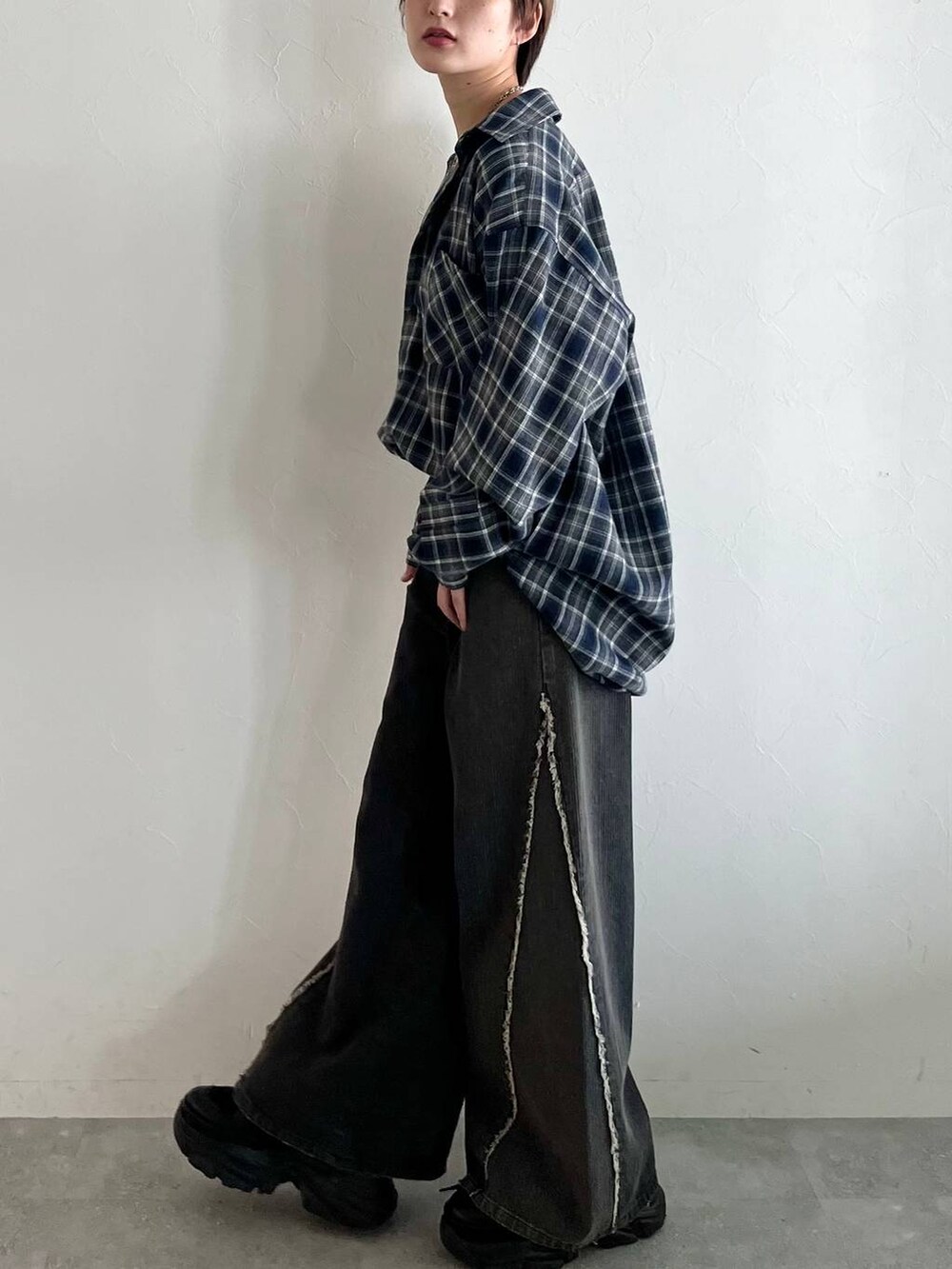 ブラック系のスニーカー、ブルー系のシャツ/ブラウス、ブラック系のデニムパンツを着用したレディースの秋コーディネートの6枚目の写真