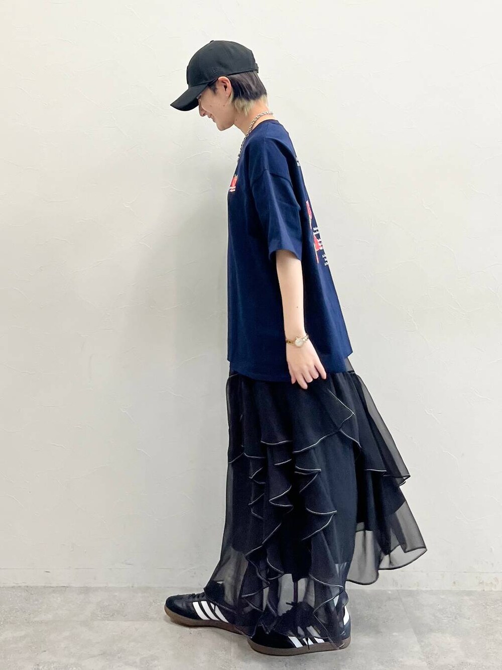ブラック系のスカート、ブラック系のスニーカー、ブルー系のTシャツ/カットソーを着用したレディースの春コーディネートの4枚目の写真