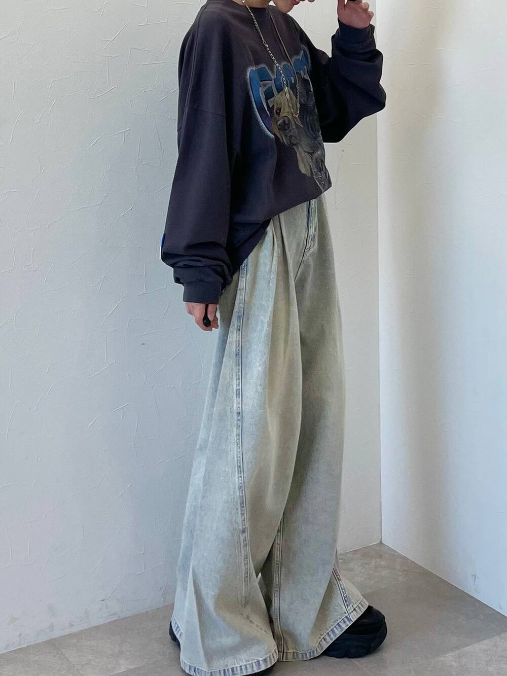 ブラック系のスニーカー、ブルー系のデニムパンツ、ブラック系のキャップを着用したレディースの春コーディネートの4枚目の写真