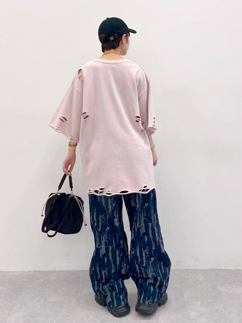 ブラック系のスニーカー、ブラック系のショルダーバッグ、ピンク系のTシャツ/カットソーを着用したレディースの夏コーディネートの8枚目の写真