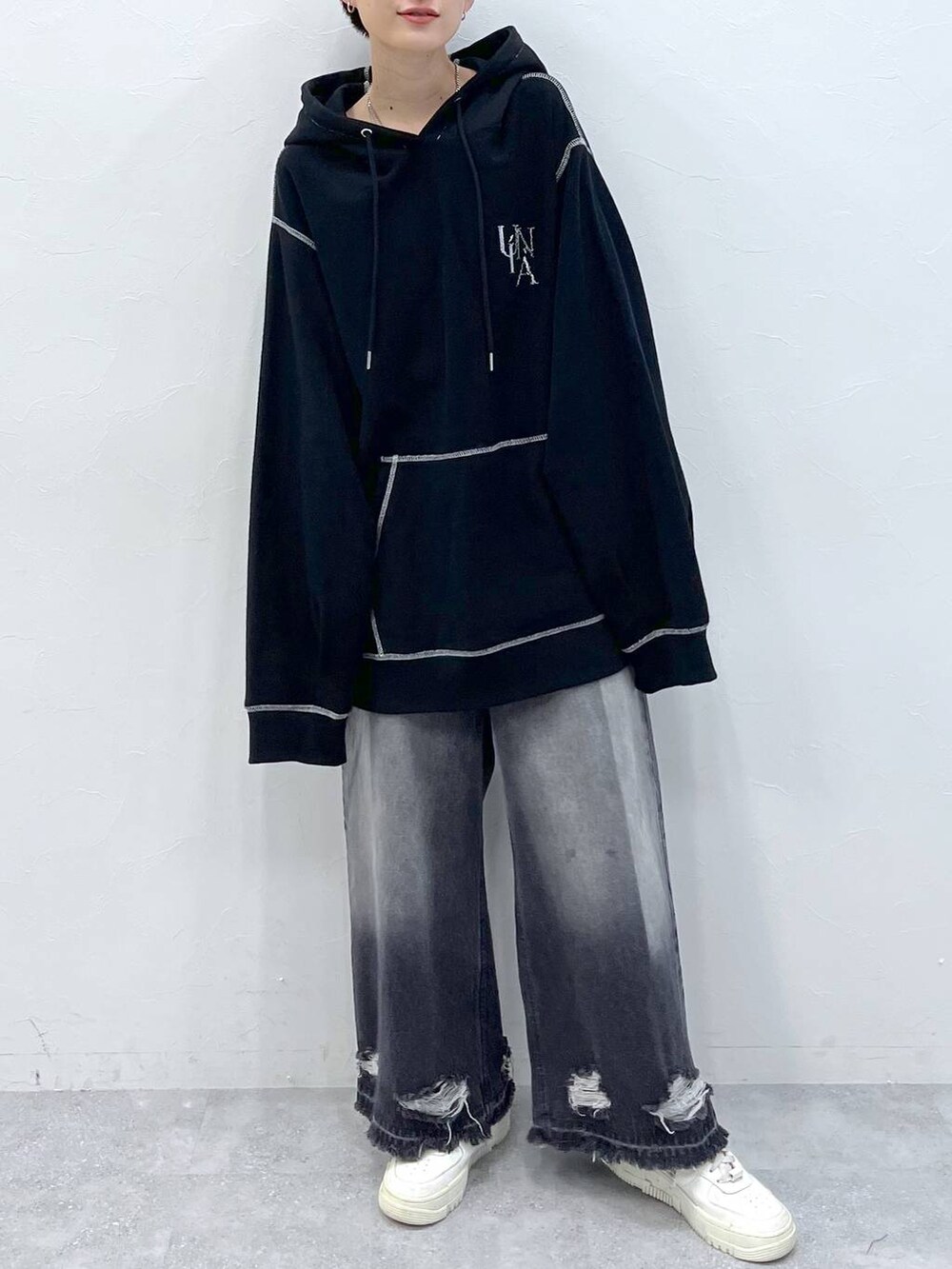 ブラック系のデニムパンツ、ブラック系のパーカーを着用したレディースの秋コーディネートの2枚目の写真