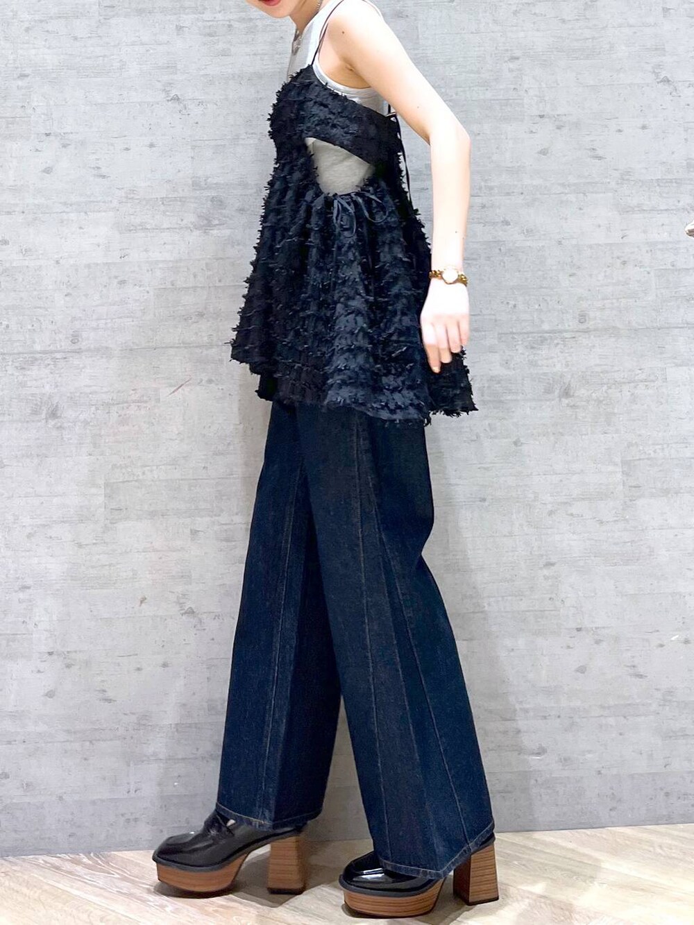 ブルー系のデニムパンツ、ブラック系のローファー、ブラウン系のショルダーバッグを着用したレディースの夏コーディネートの4枚目の写真