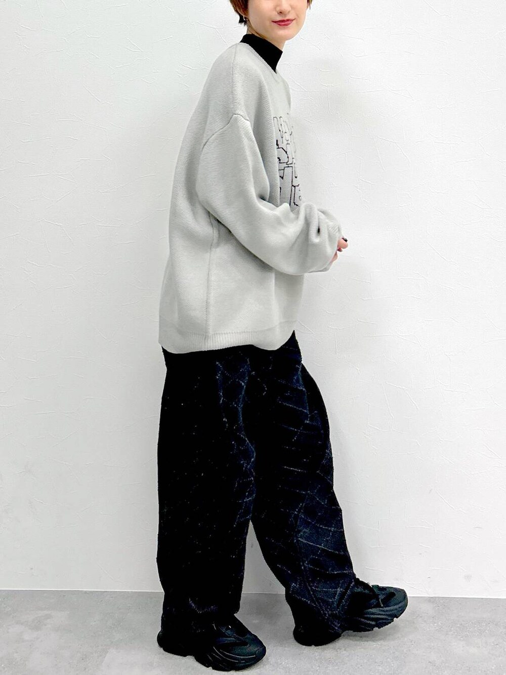 ブラック系のデニムパンツ、グレー系のニット/セーターを着用したレディースの冬コーディネートの6枚目の写真