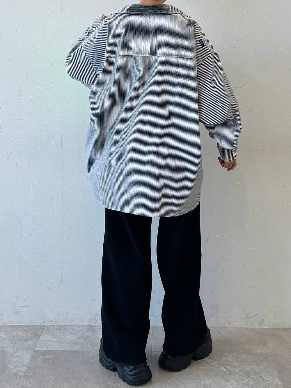 ブラック系のスニーカー、ブラック系のチノパンツ、ブラック系のキャップを着用したレディースの春コーディネートの8枚目の写真