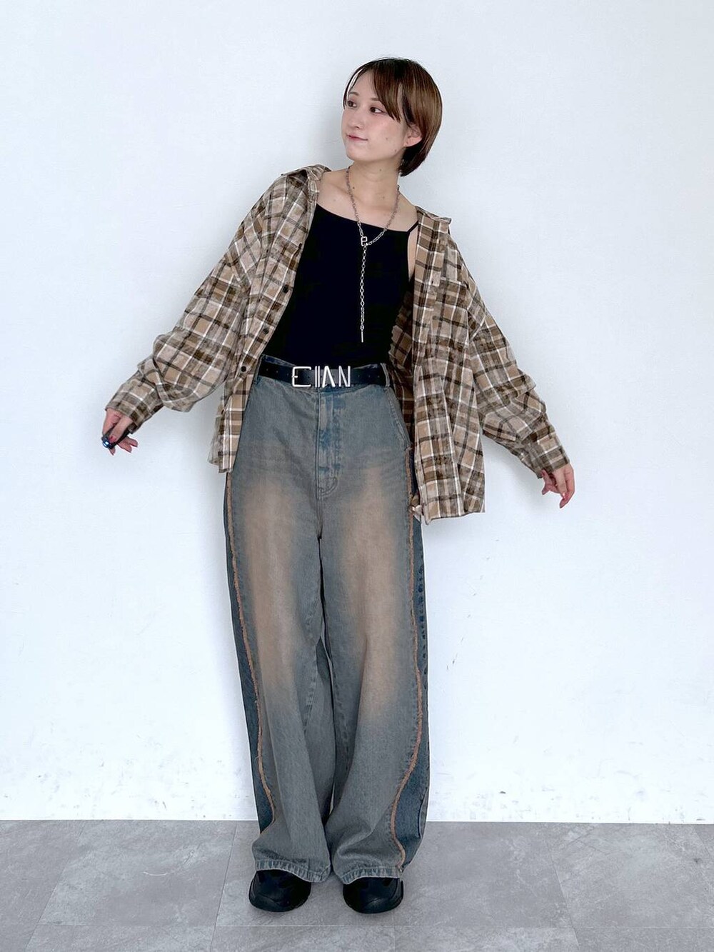 ブルー系のデニムパンツ、ブラウン系のシャツ/ブラウス、ブラック系のベルトを着用したレディースの夏コーディネートの9枚目の写真