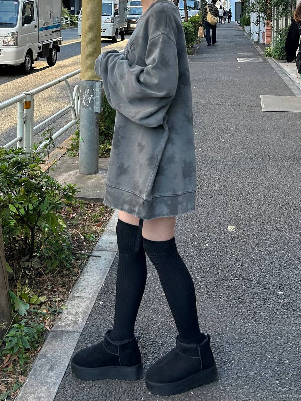 ブラック系のブーツ、ブラック系のスカート、グレー系のスウェットを着用したレディースの冬コーディネートの7枚目の写真