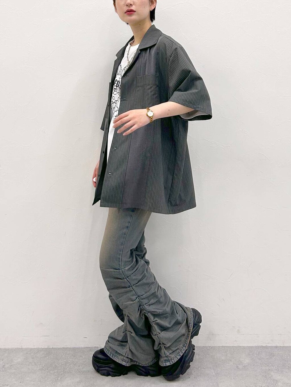 ブラック系のスニーカー、ホワイト系のTシャツ/カットソー、グレー系のシャツ/ブラウスを着用したレディースの夏コーディネートの4枚目の写真