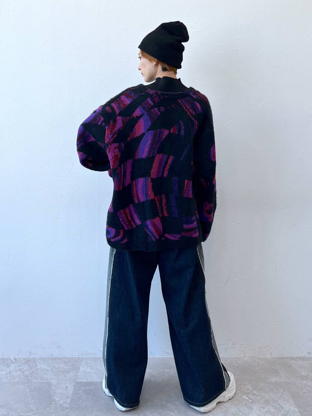 ブルー系のデニムパンツ、ブラック系のニット/セーター、ブラック系のニットキャップ/ビーニーを着用したレディースの秋コーディネートの8枚目の写真