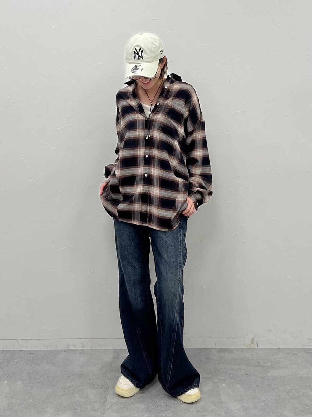 ブルー系のデニムパンツ、ブラウン系のシャツ/ブラウス、ホワイト系のTシャツ/カットソーを着用したレディースの夏コーディネートの2枚目の写真